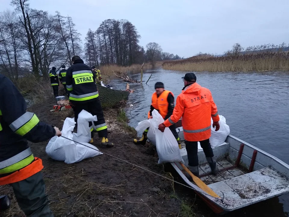 Strażacy z powiatu łęczyckiego pracują przy wzmacnianiu wału przeciwpowodziowego w miejscowości Kosew